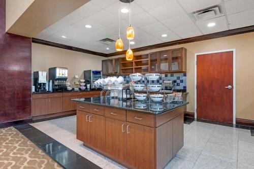 a kitchen with a counter with bowls on it at Comfort Inn & Suites Tavares North in Tavares