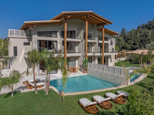 an aerial view of a villa with a swimming pool at Vadis Luxury Villa Rhodes in Koskinou
