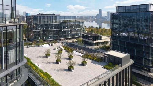 an aerial view of a courtyard in a city with buildings at Doubletree By Hilton Chengdu Xinglong Lake in Chengdu