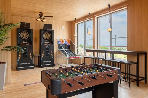 a room with a foosball table in the middle at The BONDS SPAオーシャンプライベートヴィラー千葉白浜ー in Minamiboso
