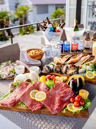 a table topped with lots of different types of food at The BONDS SPAオーシャンプライベートヴィラー千葉白浜ー in Minamiboso