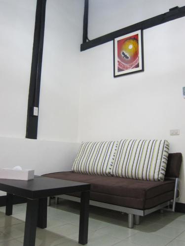 a couch and a table in a room at Runners' House Taitung in Changbin