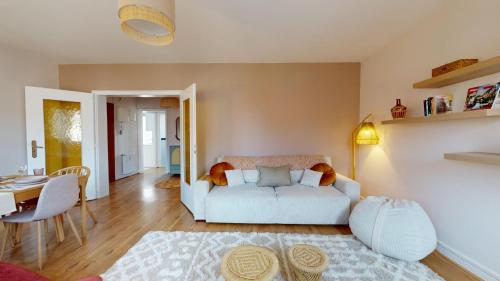 un salon avec un canapé blanc et une table dans l'établissement Chez Léa 1 Parking, à Colmar