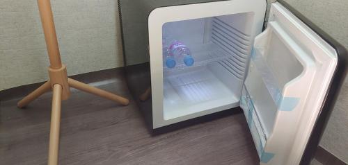 a small refrigerator with a toy inside of it at Stayin Myeongdong Guesthouse - Foreigners only in Seoul