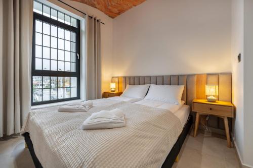 En eller flere senge i et værelse på Apartamenty Grossa - Dream Apart