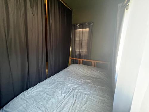 a small bed in a room with a window at Quesada Homestay in San Francisco