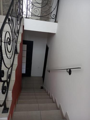 a staircase with a metal railing and a stair case at Kuća za odmor sa 3 spavaće sobe in Kragujevac