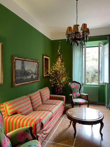 a living room with a couch and a christmas tree at Casa Mariuccia in Anzio