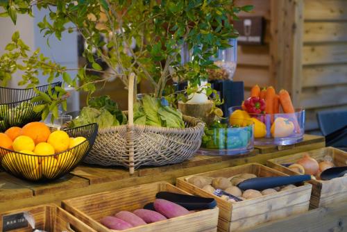 a table topped with baskets of fruits and vegetables at The BASE GLAMPING YUGAWARA in Yugawara
