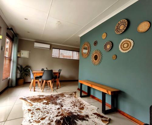 a living room with a table and a blue wall at Harrismith Country Cottage in Harrismith