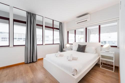 En eller flere senge i et værelse på GuestReady - Paragon in Porto