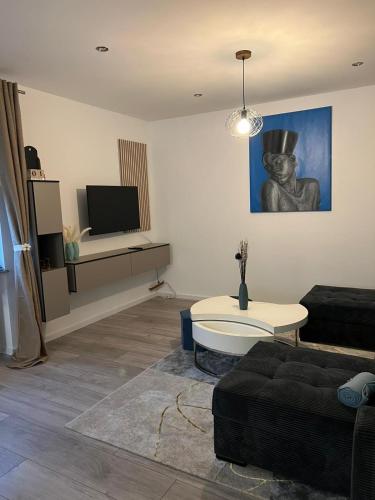 a living room with a couch and a tv at Ferienwohnung Mobembo in Konz