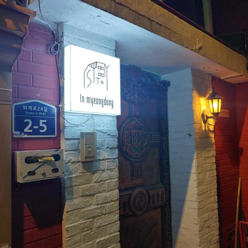 a sign on the side of a building next to a door at Stayin Myeongdong Guesthouse - Foreigners only in Seoul