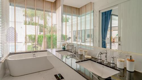 a bathroom with two sinks and a large tub at Bang Tao Villa - Menara Hill in Phuket Town