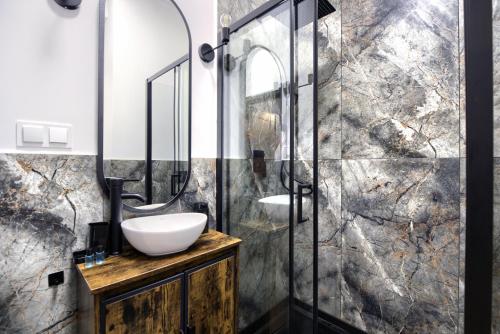 a bathroom with a sink and a shower at AboutArtApartments - By the river in Wrocław