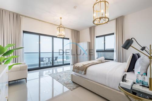 a bedroom with a view of the ocean at Elegant 4BR Villa with Assistant Room in Al Dana Island, Sharm, Fujairah by Deluxe Holiday Homes in Fujairah