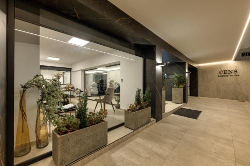 a hallway with potted plants in a building at Gold Suites in Ioannina