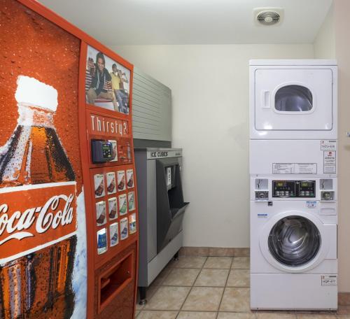 a laundry room with a coke machine and a refrigerator at Red Roof Inn PLUS+ Columbus Downtown - Convention Center in Columbus