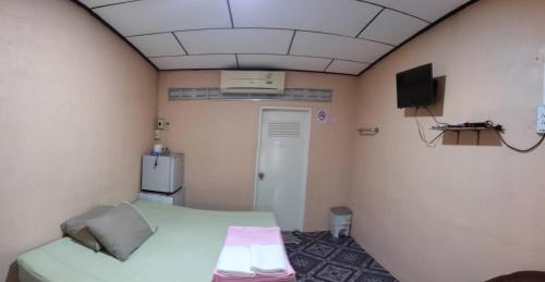 a hospital room with a bed and a tv at Chattong resort in Trat