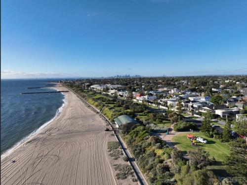 an aerial view of a beach with houses at Beach Road Hampton Holidays in Melbourne