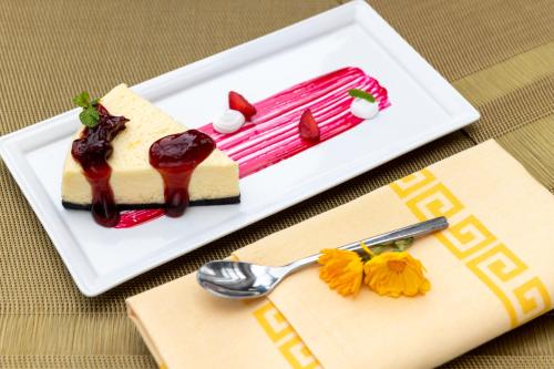 a piece of cake on a plate on a table at Vivanta Tawang in Tawang