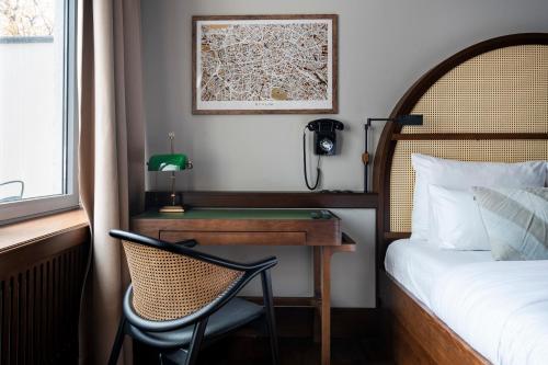 a bedroom with a desk and a bed and a chair at Numa Berlin Potsdamer Platz in Berlin