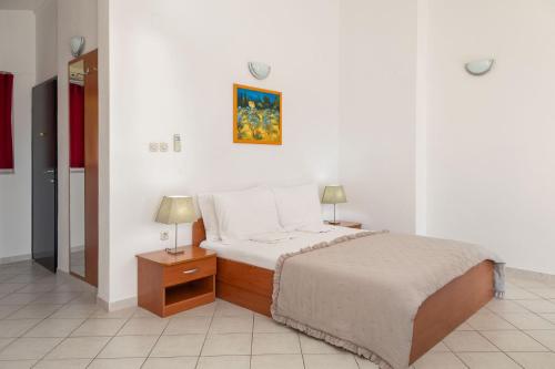 a bedroom with a bed and two lamps on a table at Apartments POLARIS in Baška Voda