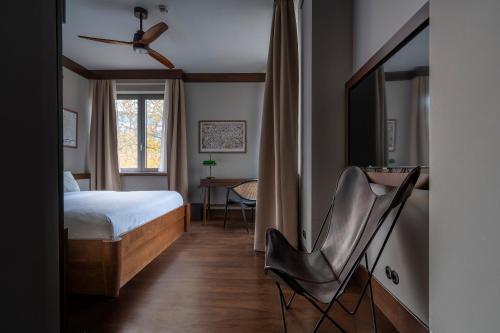 a bedroom with a bed and a chair at Numa Berlin Potsdamer Platz in Berlin