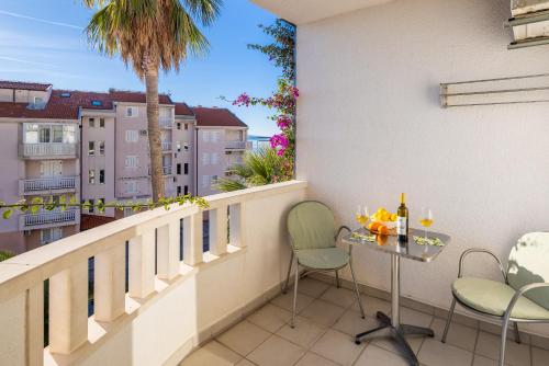 a balcony with a table and chairs and a view at Apartments POLARIS in Baška Voda