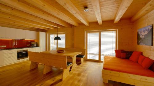 a living room with a table and a couch at Ferienwohnung Zillertal - Schwemberger in Fügen