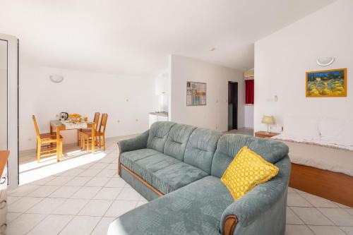 a living room with a couch and a dining room at Apartments POLARIS in Baška Voda