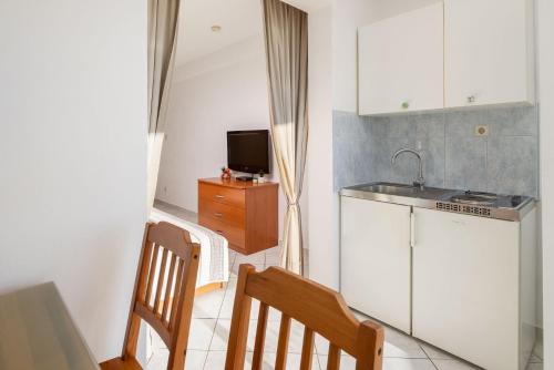 a kitchen with a sink and a counter top at Apartments POLARIS in Baška Voda