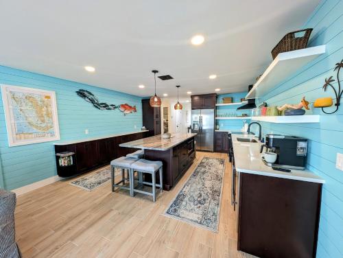 a kitchen with blue walls and a counter top at The Fish Shack in Saint James City