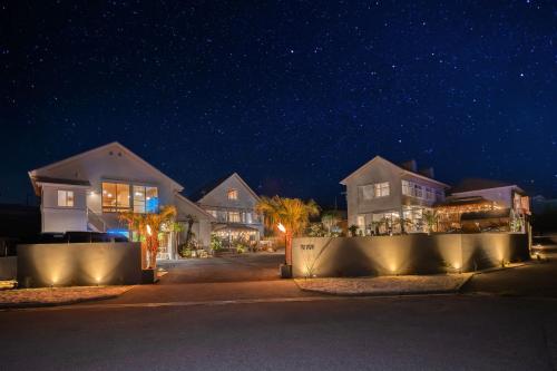 a row of houses at night with lights at The BONDS SPAオーシャンプライベートヴィラー千葉白浜ー in Minamiboso