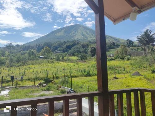 a view of a mountain from a balcony at Lokon Vila and Camp in Tomohon