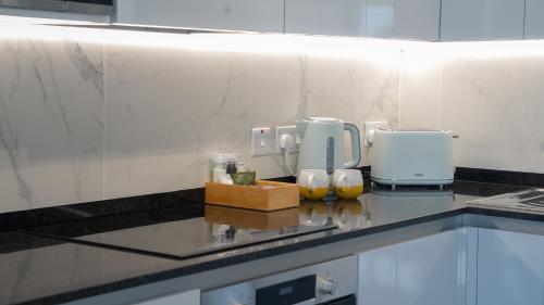 a kitchen with a counter with a coffee maker on it at E1 Suites & Spa aparthotel style - Gym & Spa in Gibraltar