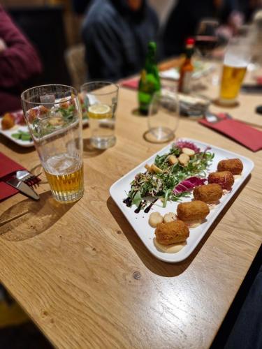 a plate of food on a wooden table at Kyriad Carcassonne - Aéroport in Carcassonne