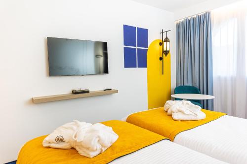 Postel nebo postele na pokoji v ubytování Hotel Carlton