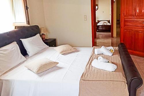 a large white bed with two towels on it at Chania's Diamond Villas - Aqua Bliss with Private Pools in Gavalochori