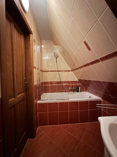 a bathroom with a shower and a tub and a sink at Star in Poprad
