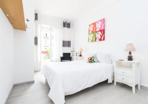une chambre blanche avec un lit blanc et un bureau dans l'établissement Beautiful & spacious 2 bed Apt near Nice Center, à Nice