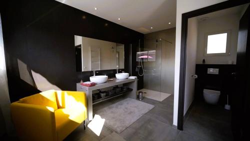 un bagno con lavandino, WC e specchio di Villa Suarticcia, 6 pers, piscine chauffée, 3 min plage en voiture a Sainte-Lucie de Porto-Vecchio