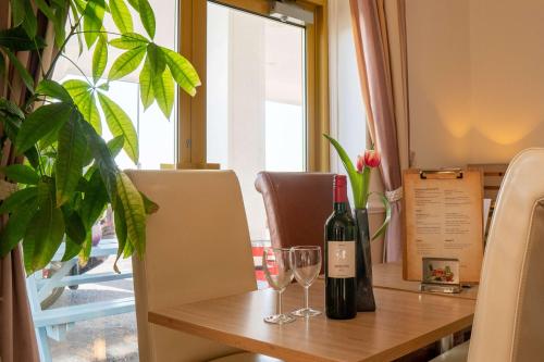 a table with two bottles of wine and glasses on it at Best Western Princes Marine Hotel in Brighton & Hove