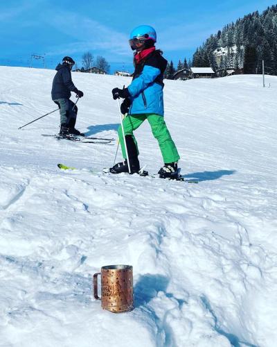 two people standing on skis in the snow at Chalet Oz in Vitznau