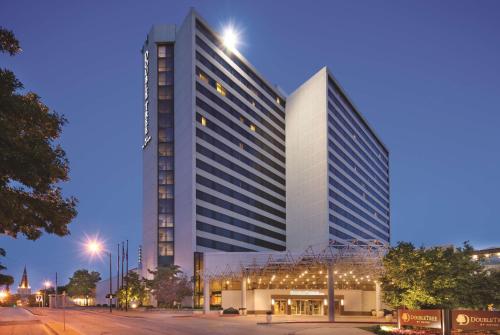 a tall building with lights in front of it at DoubleTree by Hilton Tulsa Downtown in Tulsa