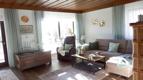 a living room with a couch and a chair at Ferienwohnung Margit in Sulzfeld