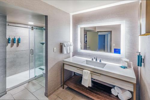 a bathroom with a sink and a shower at DoubleTree by Hilton Tulsa Downtown in Tulsa