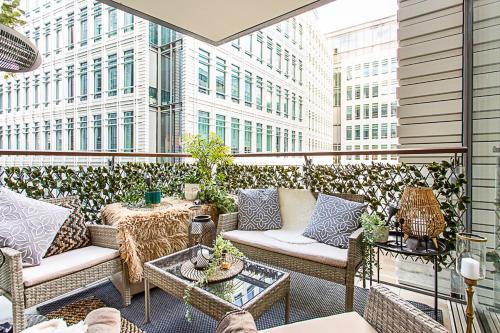 a patio with couches and tables on a building at Idyllic Covent Garden Flat in London