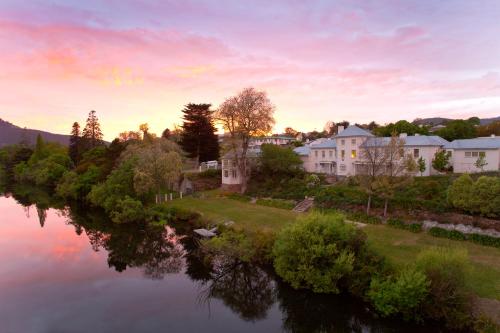 an aerial view of a house next to a river at The Woodbridge Waterfront Rooms in New Norfolk