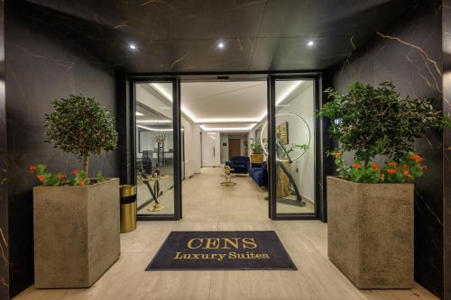 a lobby with potted plants on the walls at Cens Silver Suites in Ioannina